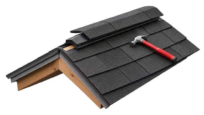 Ridge vent installed along the roof peak Ridge vent capped with shingles along a roof peak beside a red hammer.