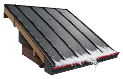 Graphite standing seam metal roof with snow sliding off its lower edge.