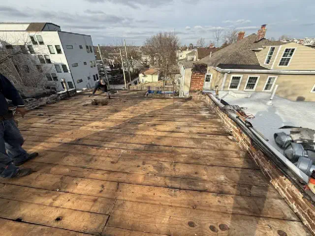 Old flat roof torn off down to the wood deck boards underneath.